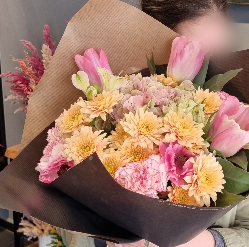 Hand-tied bouquet of soft pink and lilac flowers held in our Casablanca flower shop